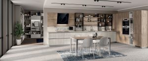 Composición en dos tonos de melamina decorativa para crear una cocina realmente confortable. Un estilo sencillo, pero impactante, que no excluye la practicidad gracias al panel posterior equipado Setup. Melamina decorativa Concrete Jersey para los muebles bajos y el armario abierto, melamina decorativa Roble Voyage para las columnas, las repisas y el panel posterior.